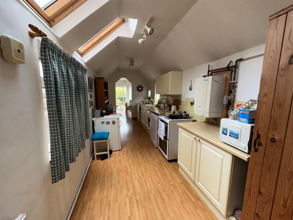 Lot: 74 - SUBSTANTIAL THREE-BEDROOM GARDEN FLAT FOR REFURBISHMENT - Kitchen looking out towards garden